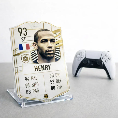 SPORTIFY CARDS
Premium acrylic display stand for small and medium football cards featuring a Thierry Henry Icon card displayed next to a PlayStation controller on a dark background. Clear plastic stand designed to showcase your personalised or pre-made FIFA football cards. The perfect way to display your Sportify Cards collection. UK and worldwide shipping.